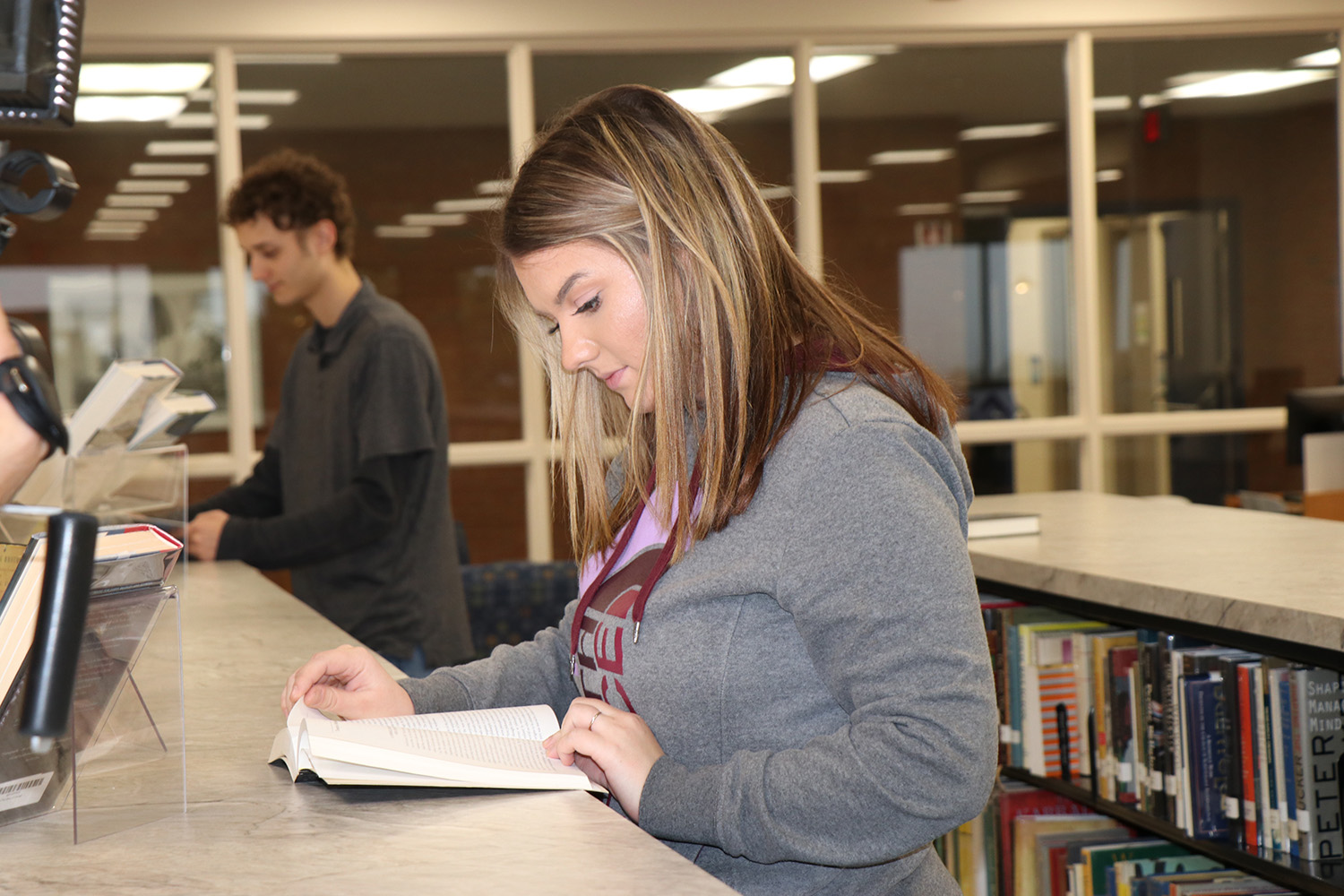 Student reading a book in the library