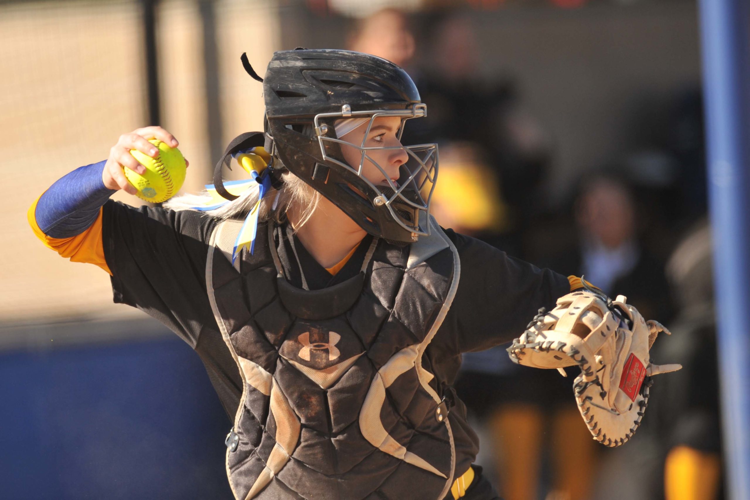 Softball catcher throwing a ball
