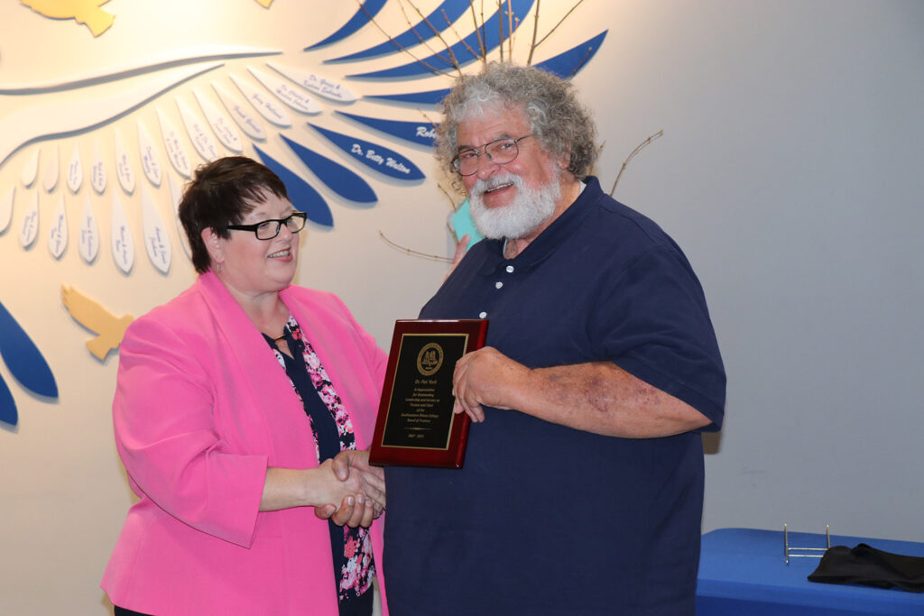 Dr York accepts retirement plaque